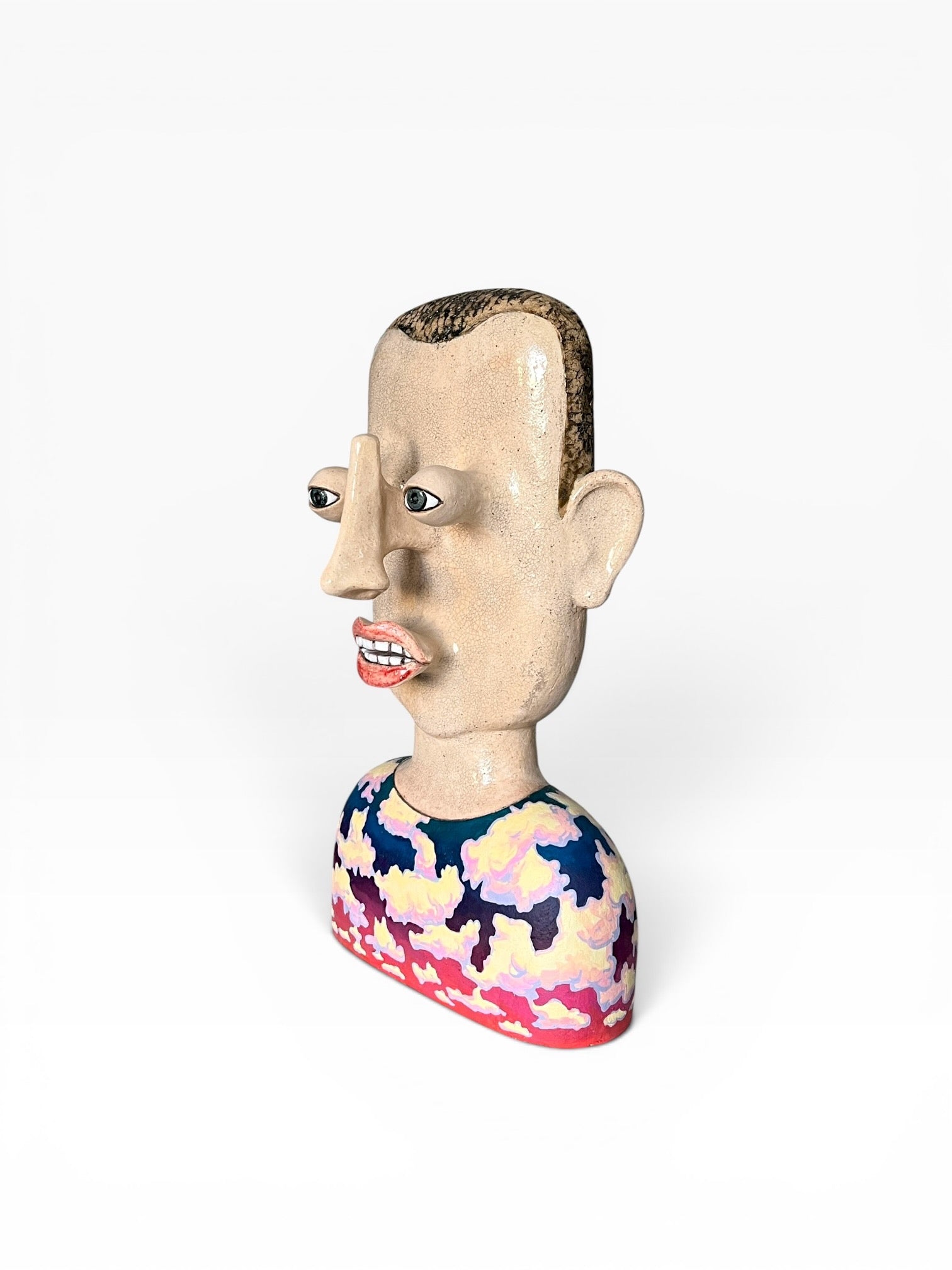 Side profile view of the large handcrafted ceramic bust Cloud Man (42x28x17 cm) showing protruding facial features, crackle glaze finish, and painted cloud torso.